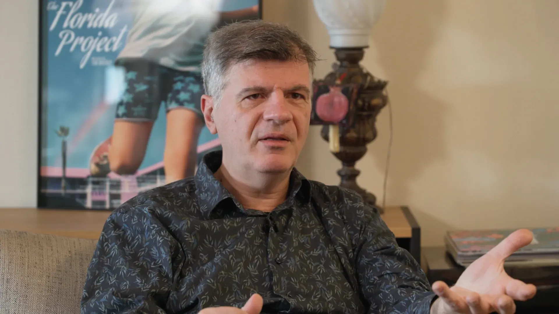 Foivos Delivorias talking in his living room