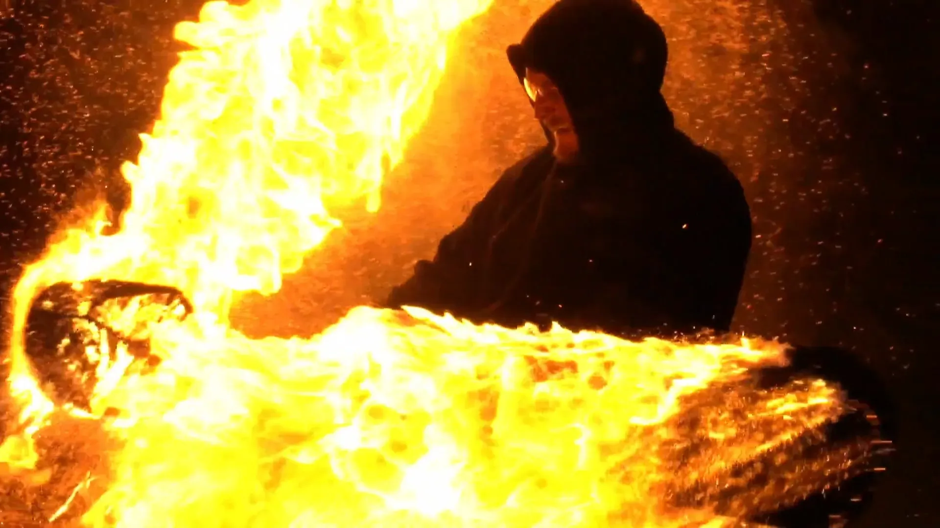 A fire performer surrounded by flames