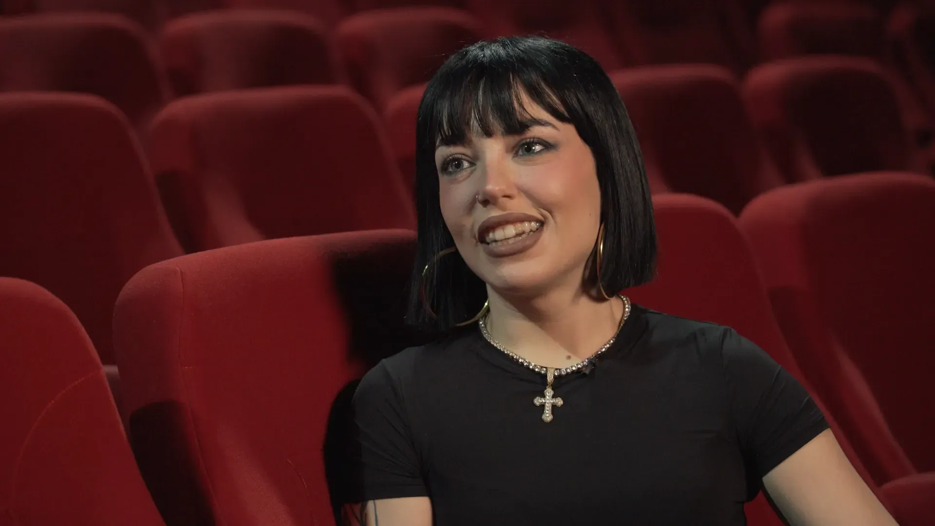Marseaux speaking in the red seats of the Bempo Theatre