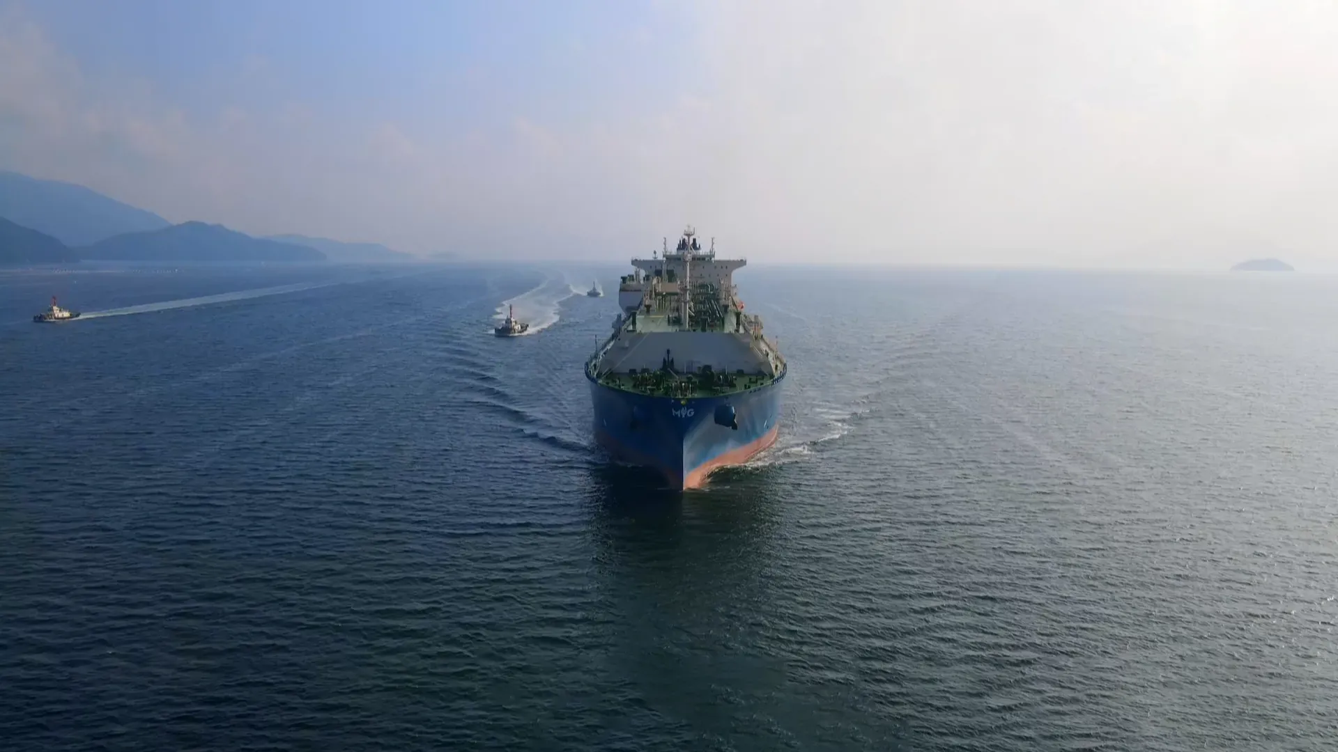Aerial view of a ship sailing out between islands