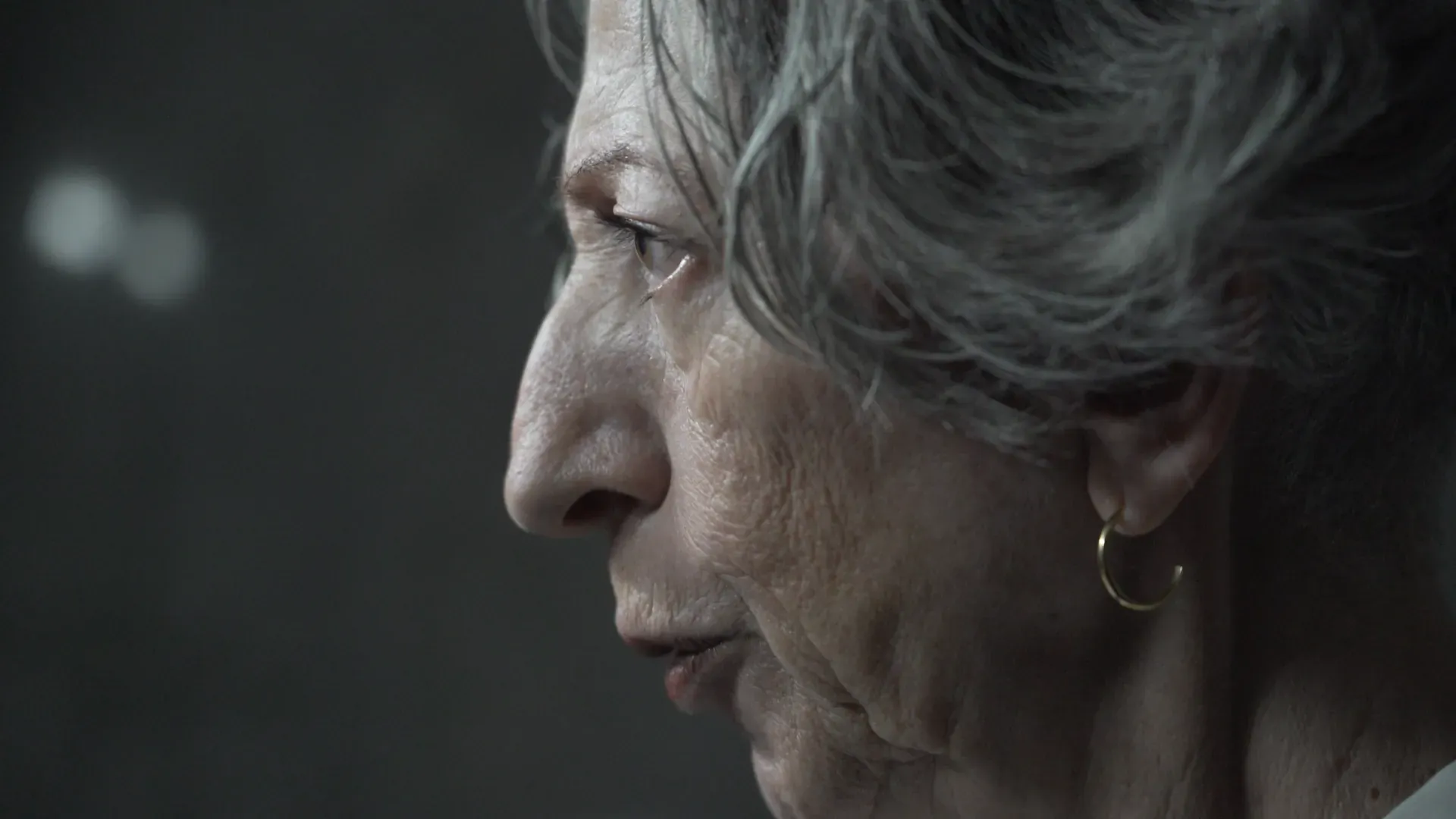 Profile of an older woman in low light