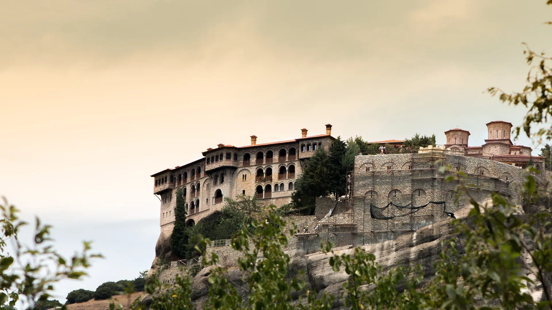 A monastery on a cliff edge above a valley