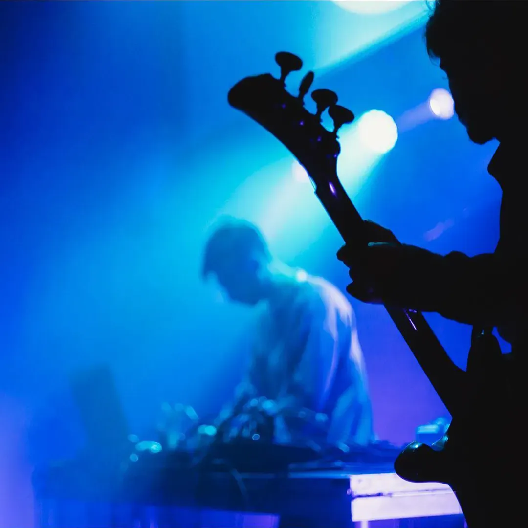 Guitarist backlit in blue