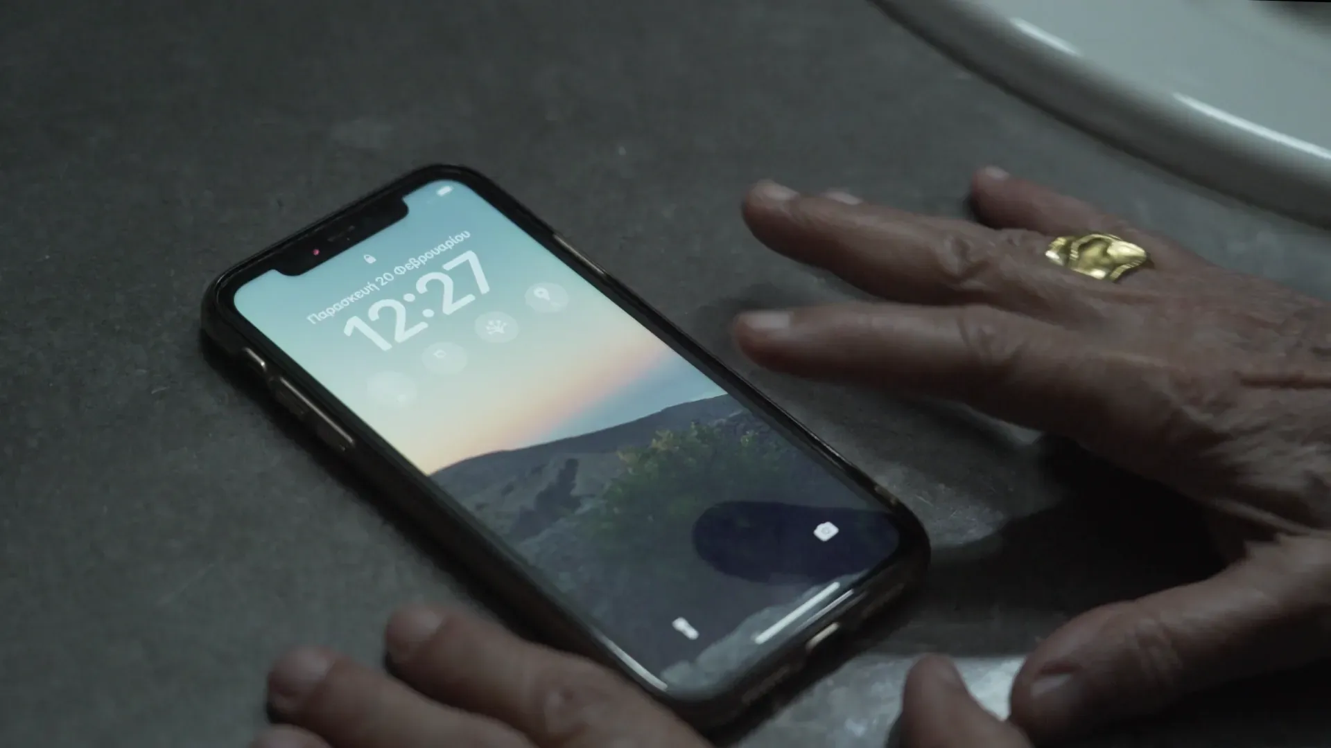 A hand beside a phone